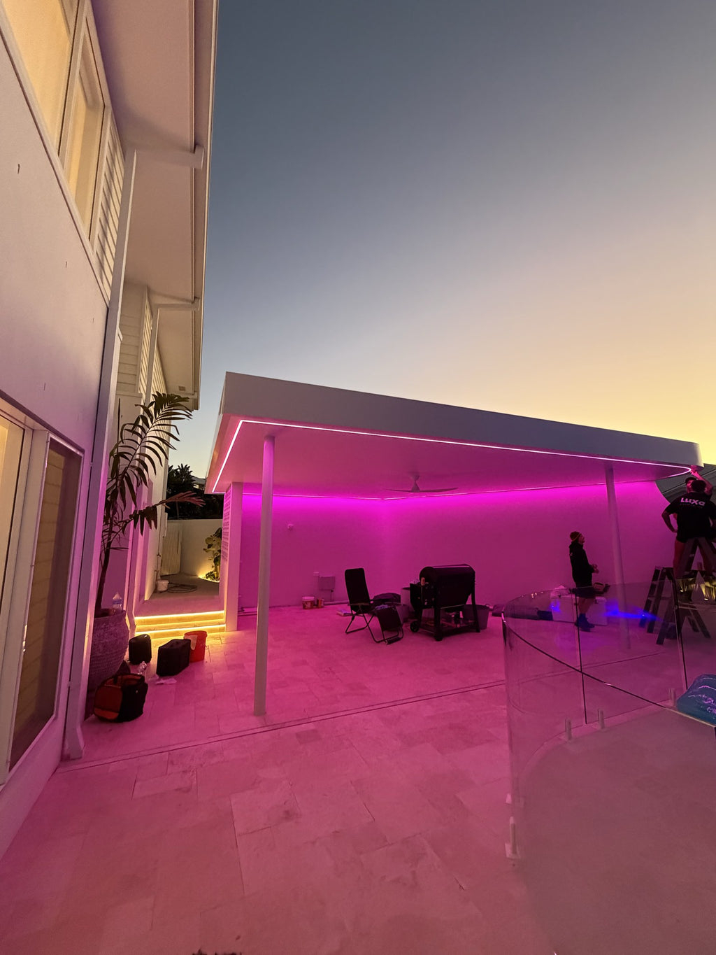 Luxe Colour RGB LED strip lighting an alfresco entertaining area in pink at dusk