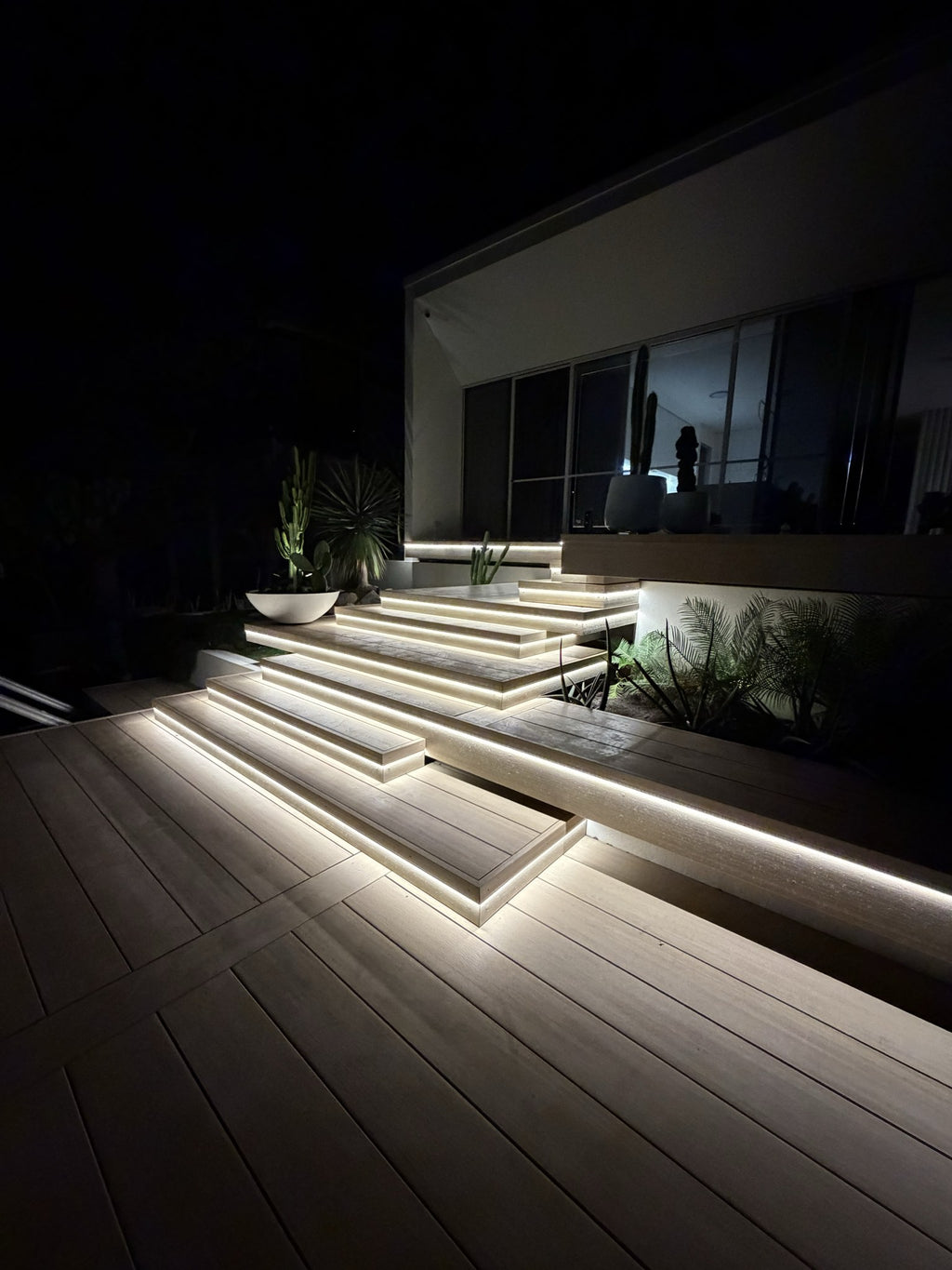 Luxe Glow warm white COB LED strip lighting on outdoor deck steps at night