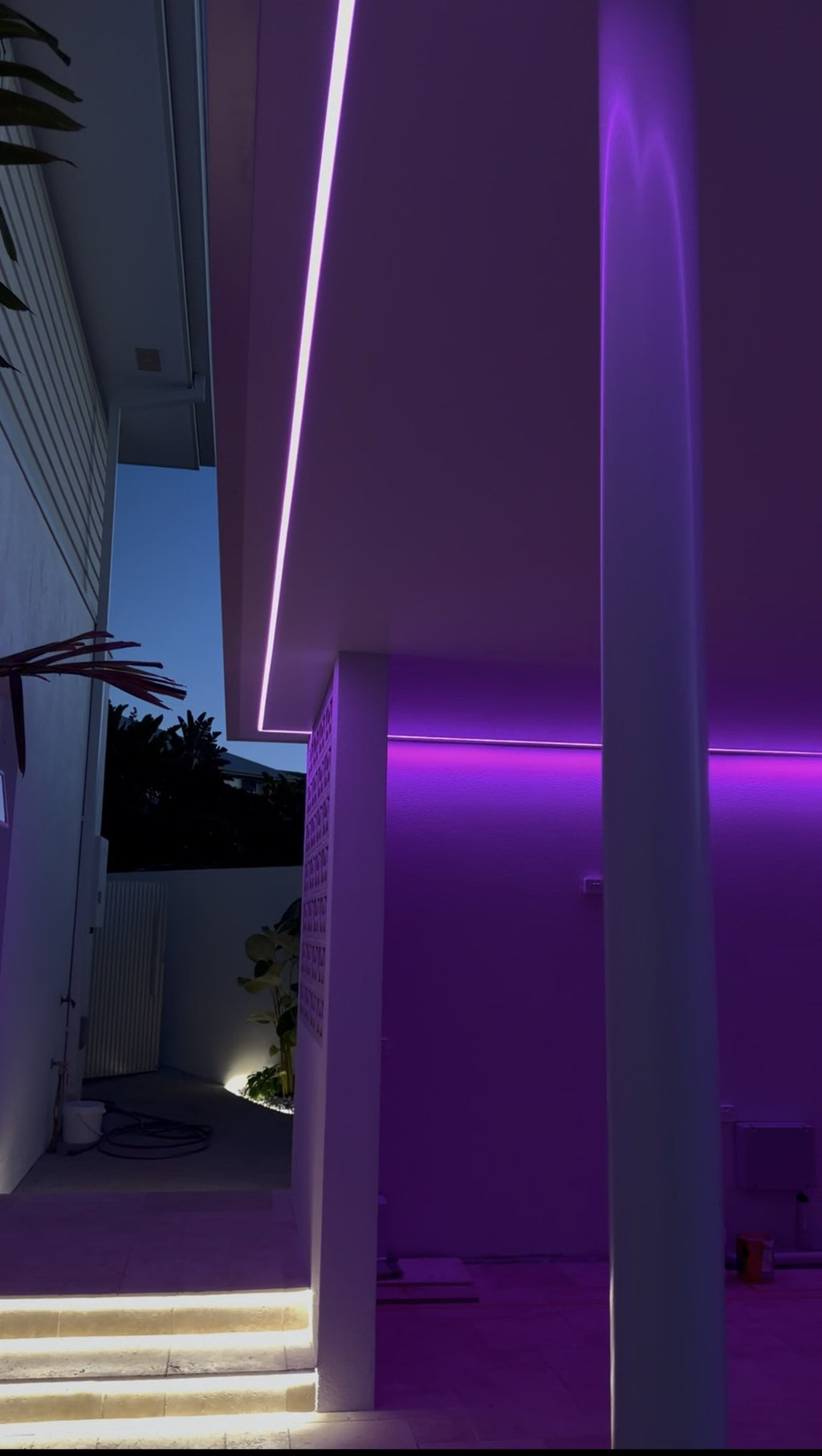 Purple RGB soffit lighting with lit steps by Luxe Electrical